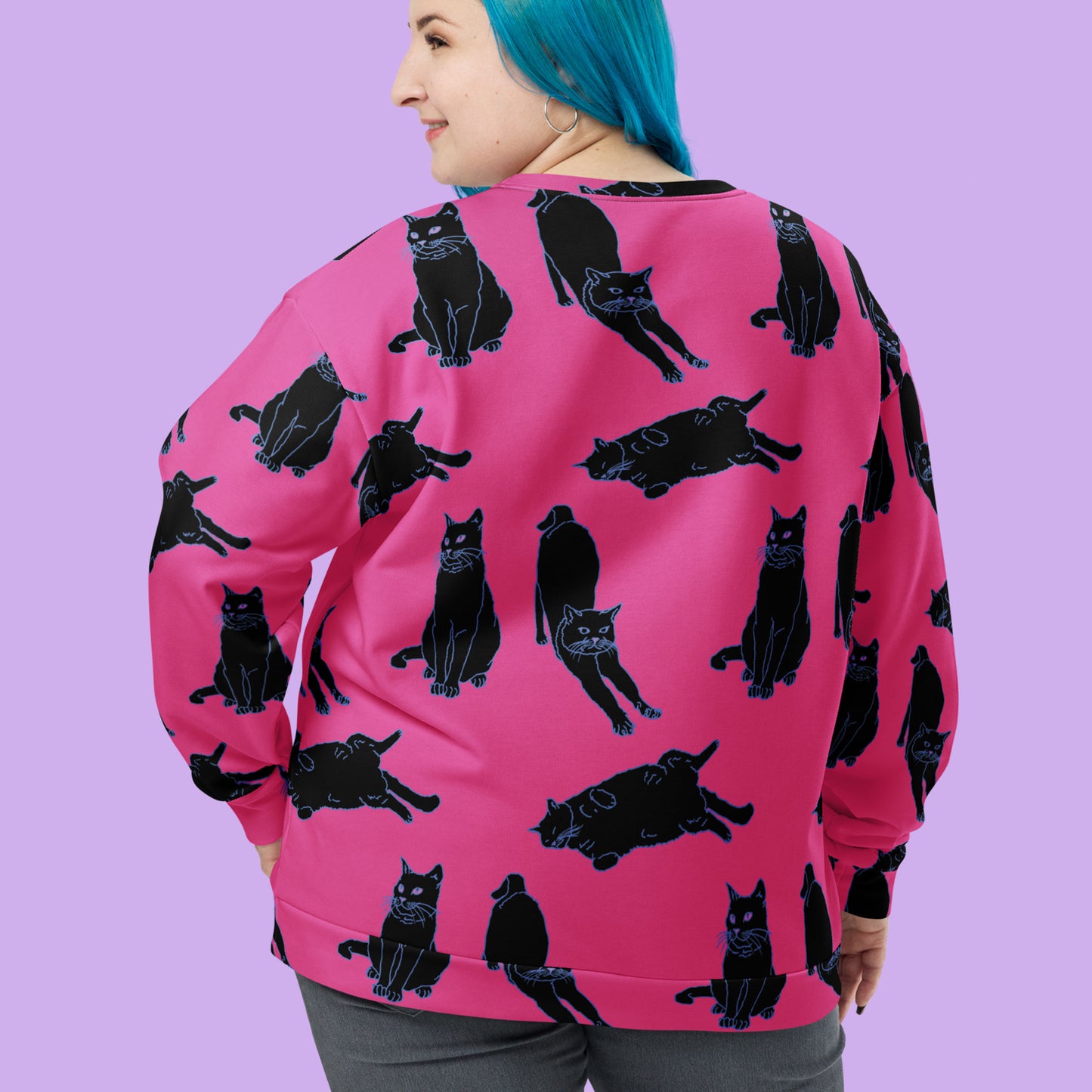 a pink sweater with a black cat print