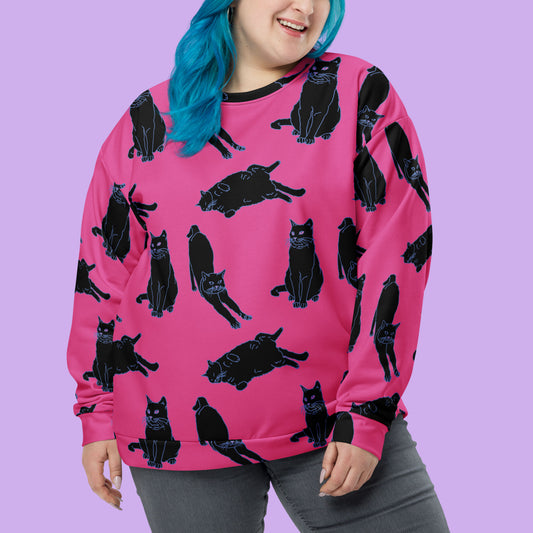 a pink sweater with a black cat print